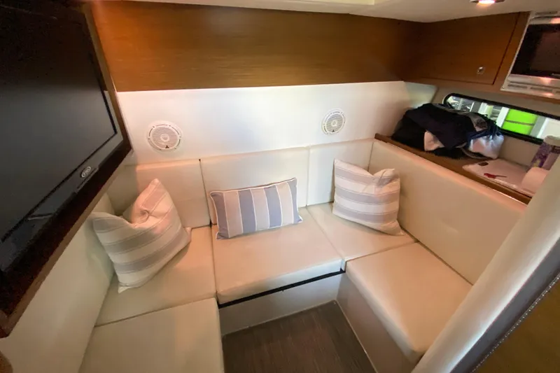 Slide: The Image of Interior of 2014 Cruisers 328 Black Diamond yacht with cozy seating and striped pillows. - 37