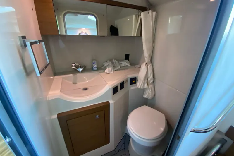 Slide: The Image of Bathroom interior of 2014 Cruisers 328 Black Diamond yacht, featuring sink and toilet. - 38