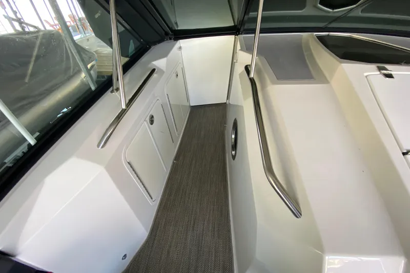 Slide: The Image of Interior view of 2014 Cruisers 328 Black Diamond boat with sleek design and handrails. - 39