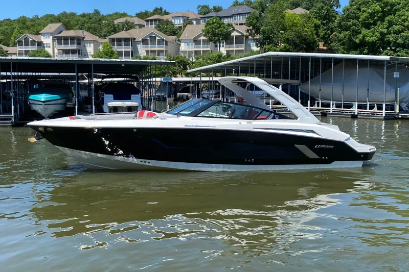 Slide: The Image of 2014 Cruisers Sport Series 328 Black Diamond boat docked on a sunny day. - 4