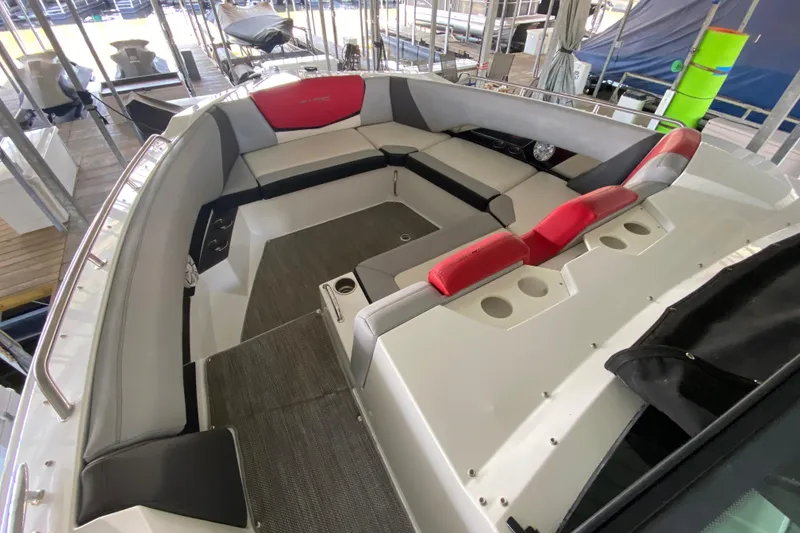Slide: The Image of 2014 Cruisers 328 Black Diamond boat interior with red and gray seating. - 40