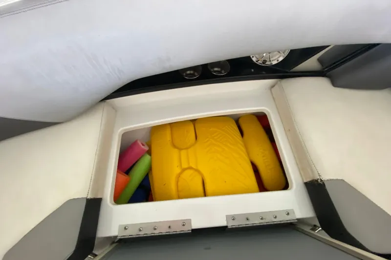 Slide: The Image of Storage compartment in 2014 Cruisers 328 Black Diamond boat with colorful pool noodles. - 43