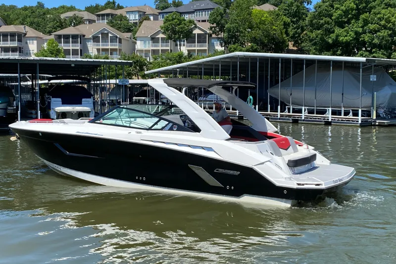 Slide: The Image of 2014 Cruisers Sport Series 328 Black Diamond boat docked on a sunny day. - 6