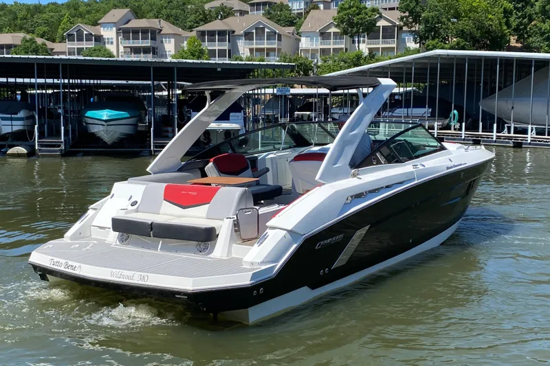 Slide: The Image of 2014 Cruisers Sport Series 328 Black Diamond boat docked in a marina. - 7