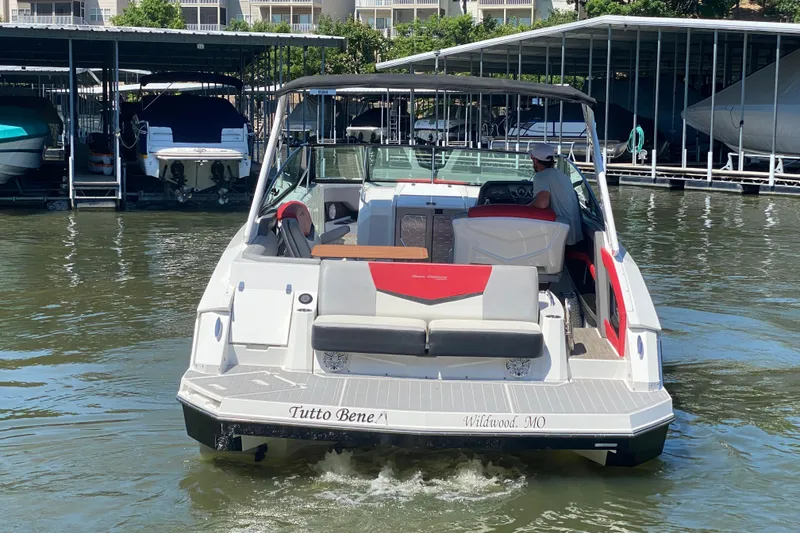 Slide: The Image of 2014 Cruisers Sport Series 328 Black Diamond boat docked on calm water. - 8