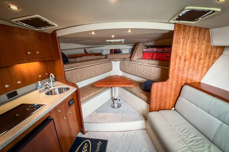 Slide: The Image of Luxurious 2006 Rampage 33 Express yacht interior with kitchenette, seating, and cozy cabin space. - 10