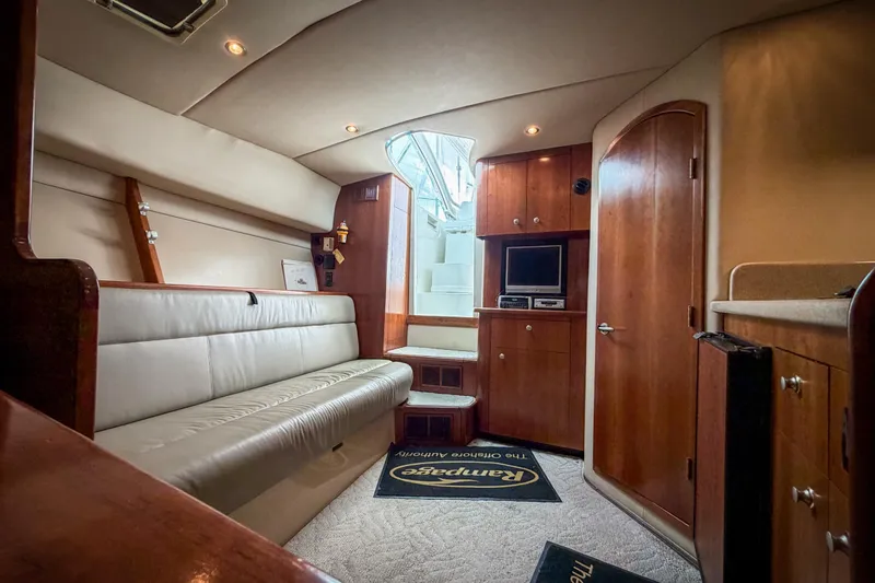 Slide: The Image of Luxurious interior of a 2006 Rampage 33 Express yacht with plush seating and wood cabinetry. - 12