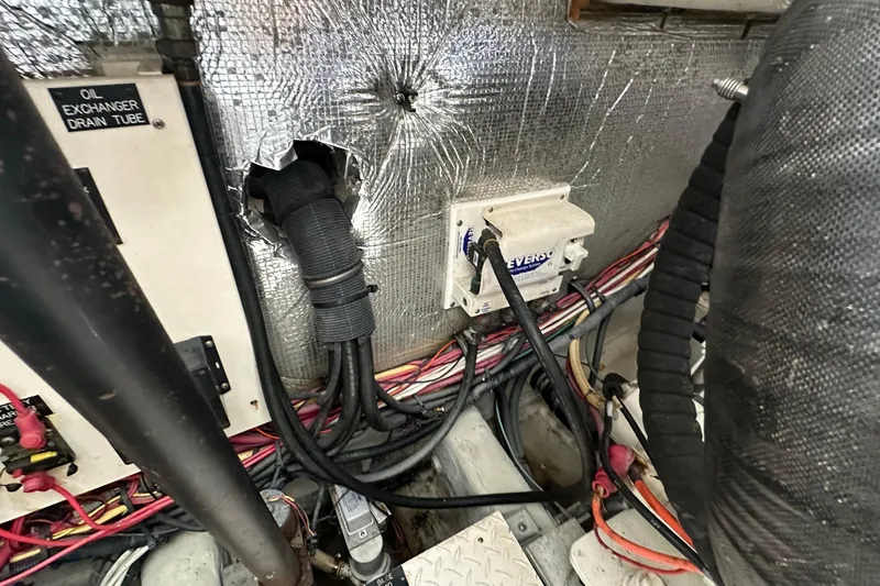 Slide: The Image of Engine compartment of 2006 Rampage 33 Express with wiring and oil exchanger drain tube. - 15
