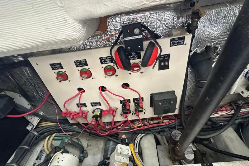 Slide: The Image of Electrical panel of a 2006 Rampage 33 Express boat with battery switches and wiring. - 16