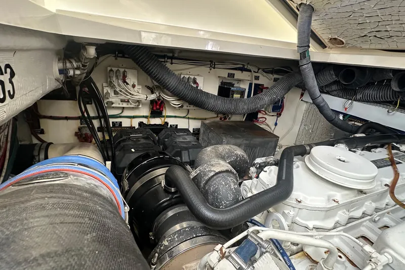 Slide: The Image of Engine room of a 2006 Rampage 33 Express boat, showcasing mechanical components and wiring. - 18
