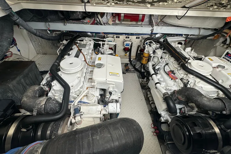 Slide: The Image of Engine room of a 2006 Rampage 33 Express boat, showcasing dual engines and mechanical components. - 19