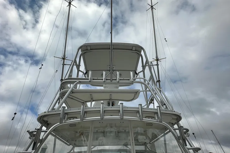 Slide: The Image of 2006 Rampage 33 Express boat tower against a cloudy sky. - 2