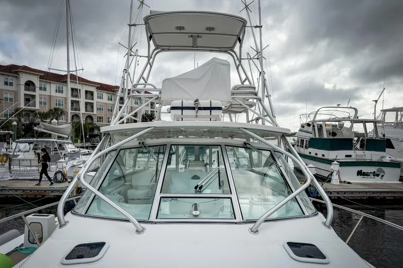 Slide: The Image of 2006 Rampage 33 Express yacht docked at marina under cloudy skies. - 3