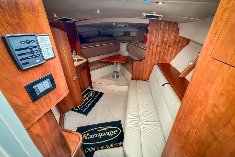 Slide: The Image of Interior of 2006 Rampage 33 Express boat with wood finish and seating area. - 7