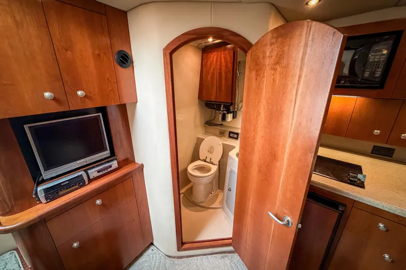 Slide: The Image of Interior of 2006 Rampage 33 Express yacht with wooden cabinetry and compact bathroom. - 8