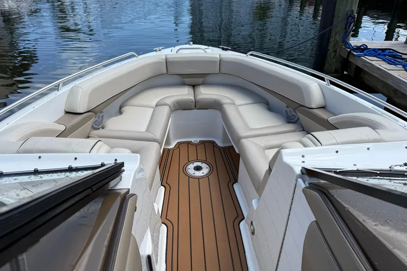 Slide: The Image of 2019 Formula 270 Bowrider boat with spacious seating and teak flooring at a dock. - 1