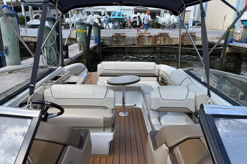 Slide: The Image of 2019 Formula 270 Bowrider interior with seating and table, docked at marina. - 2