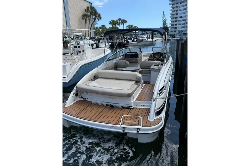 Slide: The Image of 2019 Formula 270 Bowrider docked, featuring spacious seating and sleek design. - 3