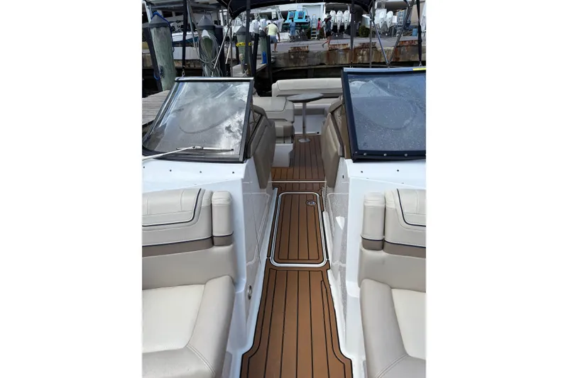 Slide: The Image of 2019 Formula 270 Bowrider interior with beige seating and wooden flooring. - 6