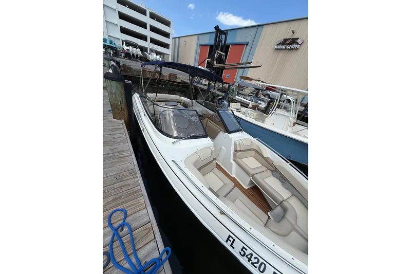 Slide: The Image of 2019 Formula 270 Bowrider docked at marina, showcasing sleek design and spacious seating. - 8