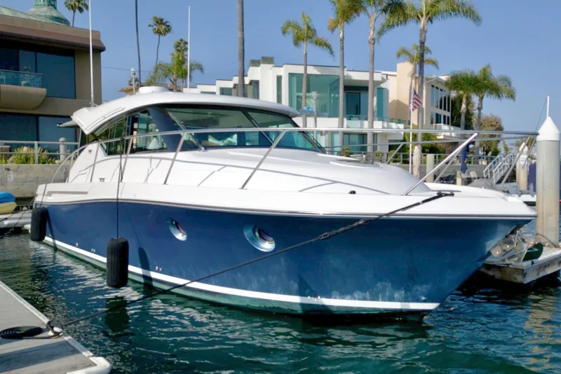The Image of 2019 Tiara Yachts Coupe 39 docked, modern architecture in background. - 0