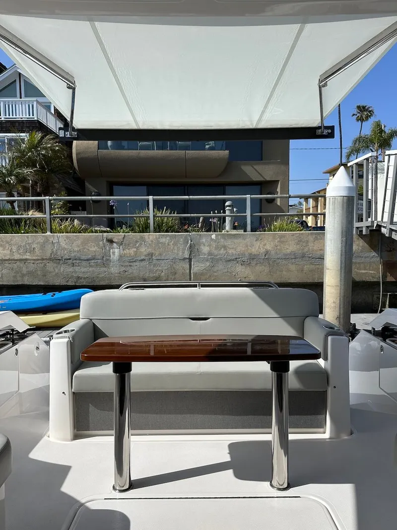 Slide: The Image of Interior view of 2019 Tiara Yachts Coupe 39 with seating area and table. - 12