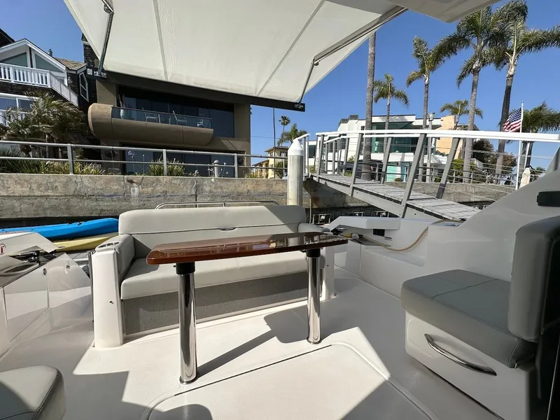 Slide: The Image of Interior of 2019 Tiara Yachts Coupe 39 with seating area and table. - 13