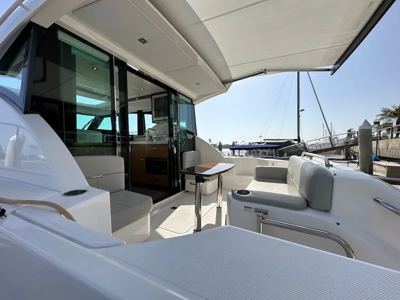 Slide: The Image of 2019 Tiara Yachts Coupe 39 with stylish deck and seating area. - 14