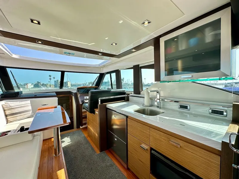 Slide: The Image of Interior of 2019 Tiara Yachts Coupe 39 with modern kitchen and seating area. - 19