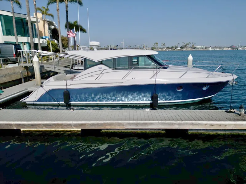 Slide: The Image of 2019 Tiara Yachts Coupe 39 docked on a sunny day. - 2
