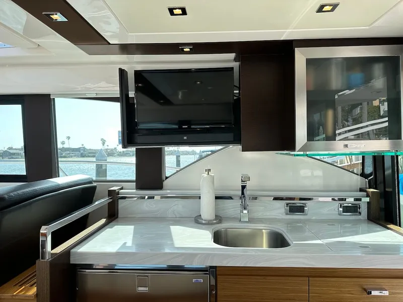 Slide: The Image of Interior of 2019 Tiara Yachts Coupe 39 with modern kitchen and TV. - 21