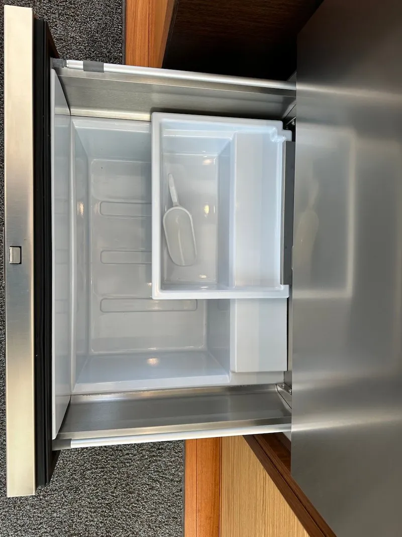 Slide: The Image of Open refrigerator with ice compartment on a 2019 Tiara Yachts Coupe 39. - 49