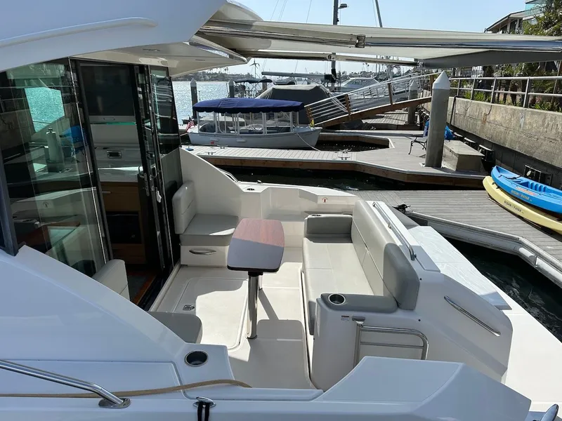 Slide: The Image of 2019 Tiara Yachts Coupe 39, luxurious outdoor seating at dock. - 6