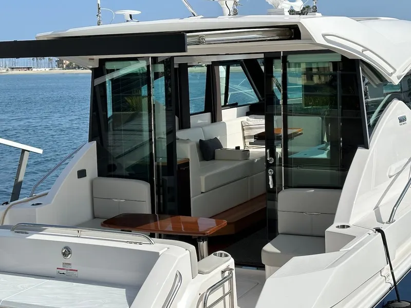 Slide: The Image of 2019 Tiara Yachts Coupe 39 with luxurious interior by the water. - 8