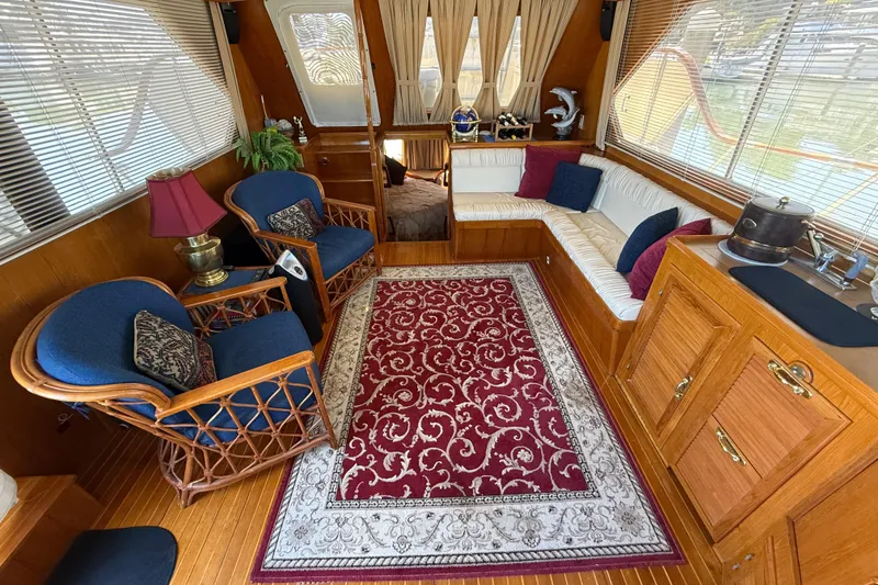 Slide: The Image of Luxurious 1987 PT Sundeck yacht interior with elegant seating and decorative rug. - 10