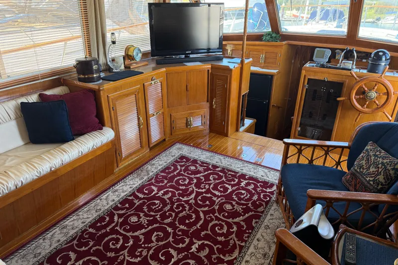 Slide: The Image of Interior of a 1987 PT Sundeck yacht with wood paneling and elegant decor. - 14