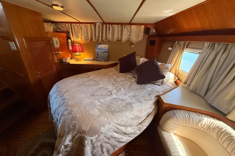 Slide: The Image of Cozy bedroom interior of 1987 PT Sundeck yacht with elegant bedding and warm lighting. - 28