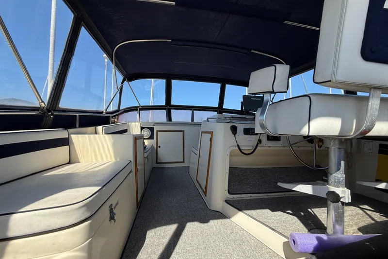 Slide: The Image of 1987 PT Sundeck boat interior with seating and helm, featuring a classic design. - 3