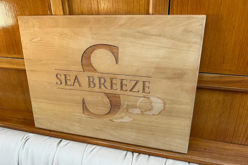 Slide: The Image of Wooden plaque with "Sea Breeze" engraving on PT Sundeck 1987 boat interior. - 39