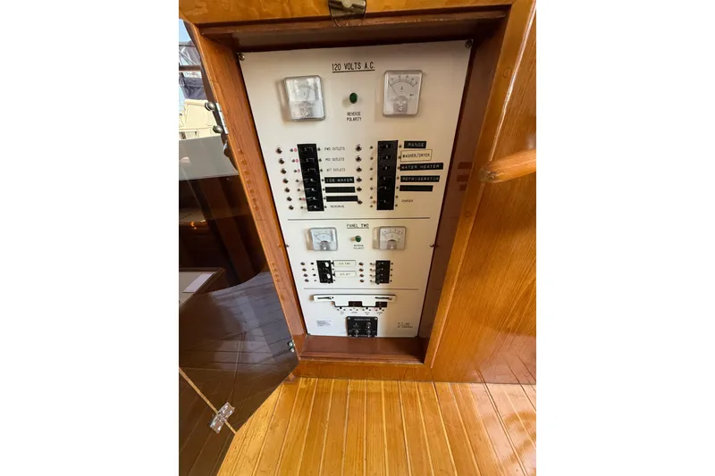 Slide: The Image of Electrical panel inside 1987 PT Sundeck boat, featuring various switches and meters. - 45