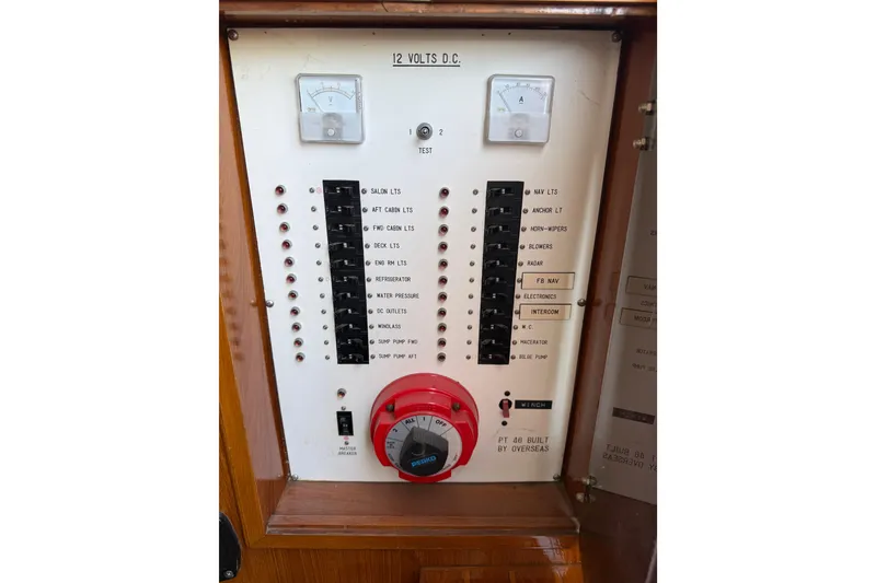 Slide: The Image of Electrical control panel of a 1987 PT Sundeck boat, featuring switches and gauges. - 48