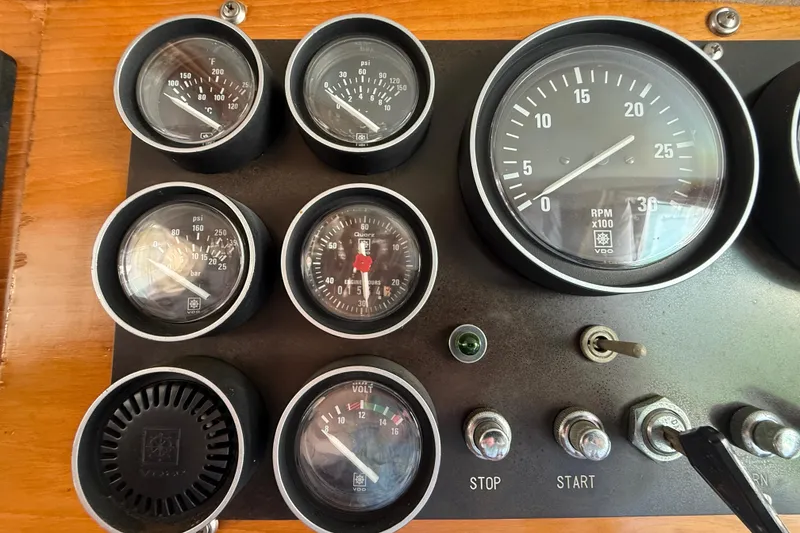 Slide: The Image of Instrument panel of a 1987 PT Sundeck boat with gauges and switches. - 50