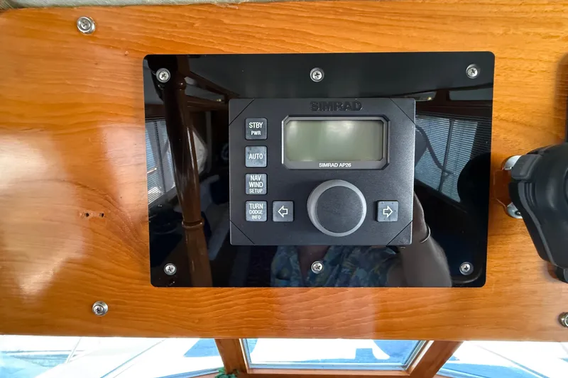 Slide: The Image of Simrad AP26 autopilot on 1987 PT Sundeck boat's wooden dashboard. - 54