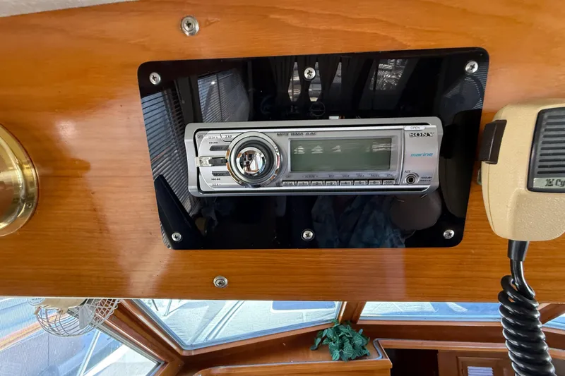 Slide: The Image of 1987 PT Sundeck boat interior with Sony marine stereo system and microphone. - 56