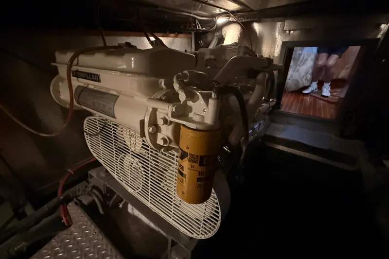 Slide: The Image of Engine room of 1987 PT Sundeck boat with visible Caterpillar engine. - 65