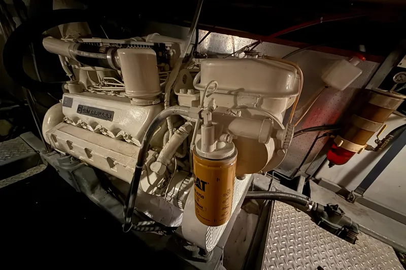 Slide: The Image of Engine room of a 1987 PT Sundeck boat featuring a Caterpillar engine. - 66
