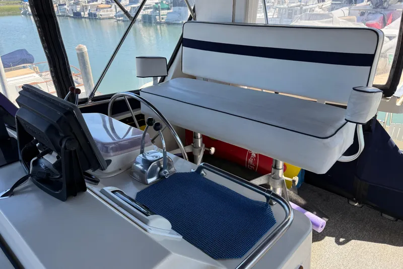 Slide: The Image of Helm of 1987 PT Sundeck boat with steering wheel and navigation equipment. - 7