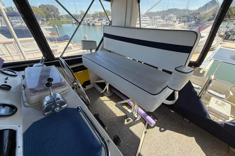 Slide: The Image of Interior of a 1987 PT Sundeck boat with helm and seating area. - 8