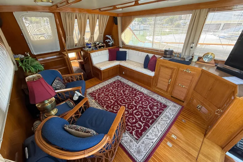Slide: The Image of Cozy 1987 PT Sundeck yacht interior with elegant wood paneling and comfortable seating. - 9