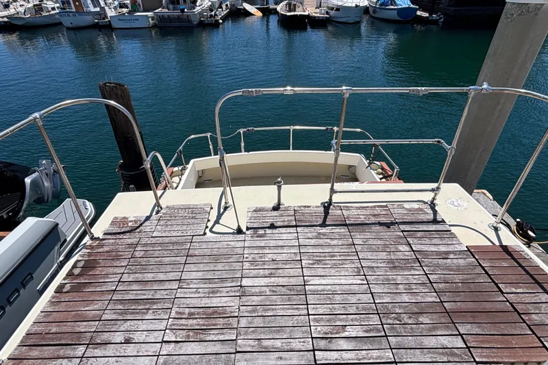 Slide: The Image of 1974 Skookum 34 boat deck overlooking marina with moored boats. - 11
